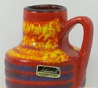 Maker’s label on body, lava glaze colours