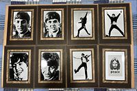 Eight framed photographs shown open, revealing individual Beatles member images and handwritten-style captions