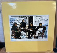 Front of laminated yellow jacket with Beatles photo insert