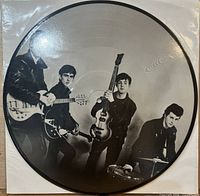 Side A of black-and-white Beatles picture disc showing group with instruments