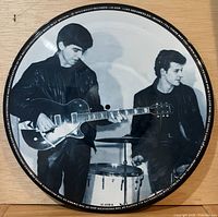 Side showing George Harrison with guitar and drummer; rim print visible