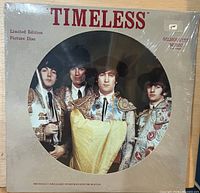 Front sleeve with die-cut window showing picture disc and title