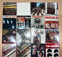Front view of 16 sealed miniature Beatles album covers arranged in four-by-four grid