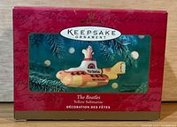 Front of red Hallmark Keepsake box with ornament image