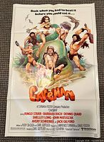 Full view of folded Caveman poster showing artwork and credits