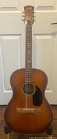 Full front view of Kent F5 acoustic guitar on stand
