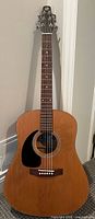 Full view of Seagull S6 guitar standing upright