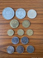 Obverse sides of all thirteen coins laid out by denomination