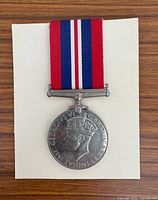 Obverse of medal with ribbon on neutral background