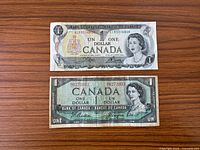 Fronts of both $1 notes showing portraits and serial numbers