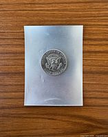 Coin in sleeve showing reverse