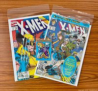 Both comics in bags with trading card