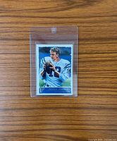 Front view of card in hard plastic case showing illustration of Peyton Manning