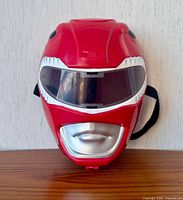 Front view of the red Power Rangers mask showing visor and mouthpiece