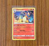Front view of Charizard card in sleeve and toploader