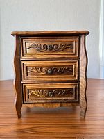 Front view showing carved three-drawer jewelry box