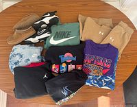 All garments and both pairs of shoes displayed together