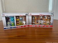 Front view of both sealed 10-pack boxes showing characters