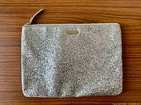 Front view showing glitter exterior, logo plate, faint pink mark