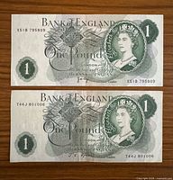 Fronts of both Bank of England £1 notes showing Queen Elizabeth II portraits and serial numbers