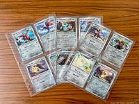 Twelve sleeved Pokémon cards fan-arranged