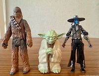 Front view of Chewbacca, Yoda and Cad Bane figures standing upright