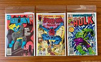 Front covers of the three bagged comics
