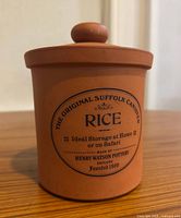 Front view of Henry Watson terracotta rice canister with lid on