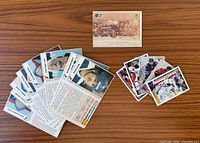 Mixed lot spread showing Esso cards backs, Ace Bailey card, Panini stickers fronts