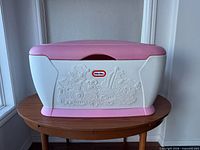 Front view of Little Tikes white and pink toy chest with lid closed