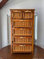 Front view showing six rattan basket drawers and wood frame