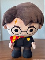 Front view of standing Harry Potter plush showing scarf, glasses, wand