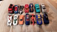 All 14 Hot Wheels cars arranged in two rows