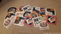All 17 assorted vintage advertising bar coasters displayed
