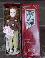 Full view of doll in original CHSN Artisan Collection box with stand and accessories visible