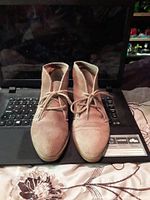 Front view of pair of suede chukka boots on laptop