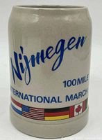 Front view of stoneware mug showing Nijmegen text, 100 Mile International March wording and flags