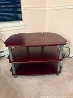 Front view showing three shelves, color, and metal supports