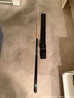 Cue assembled beside carry case