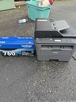 Printer and boxed TN760 toner side by side on driveway
