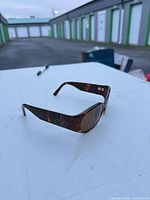 Left side view showing tortoiseshell pattern and ck logo on arm