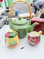 Overall view of kettle, sugar bowl, creamer