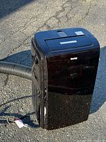 Front view of black Danby portable AC with hose attached