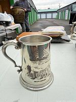 Front view of pewter tankard showing ship and church illustrations