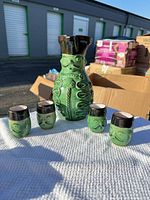 Pitcher with four matching shot cups on cloth