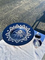 Charger with bowl center and vase grouped together on cloth