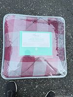 Front view of sealed package showing plaid design and label