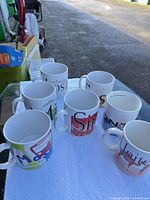 All seven Starbucks city mugs grouped on table
