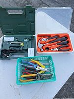 Full lot showing glue gun kit, 6-piece tool kit and basket of loose pliers/snips