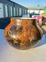 Front view of bulbous multicolor floral ceramic vase